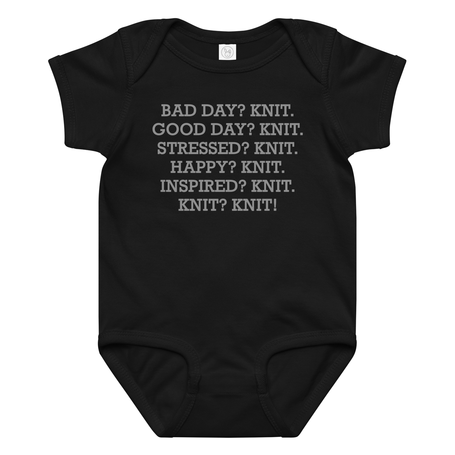 "Bad Day? Knit. Good Day? Knit. Stressed? Knit. Happy? Knit. Inspired? Knit. Knit? Knit!" printed on a black baby jersey bodysuit laying on a flat surface amongst other clothes
