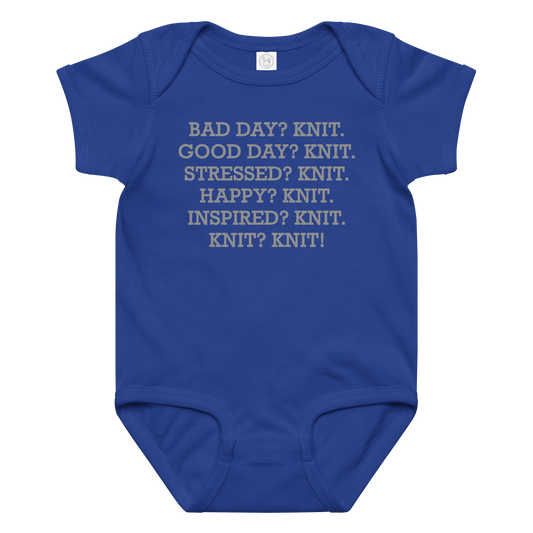 "Bad Day? Knit. Good Day? Knit. Stressed? Knit. Happy? Knit. Inspired? Knit. Knit? Knit!" printed on a royal baby jersey bodysuit laying on a flat surface amongst other clothes