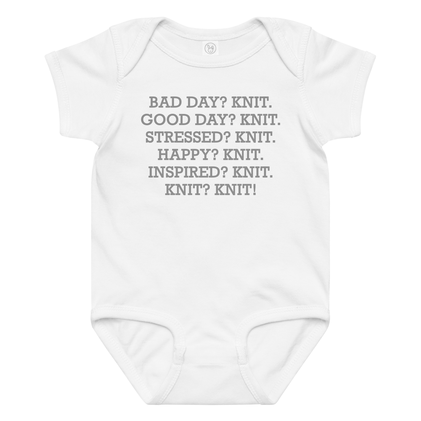 "Bad Day? Knit. Good Day? Knit. Stressed? Knit. Happy? Knit. Inspired? Knit. Knit? Knit!" printed on a white baby jersey bodysuit laying on a flat surface amongst other clothes