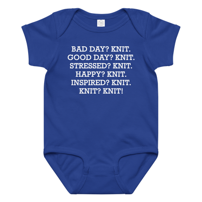 "Bad Day? Knit. Good Day? Knit. Stressed? Knit. Happy? Knit. Inspired? Knit. Knit? Knit!" printed on a royal baby jersey bodysuit laying on a flat surface amongst other clothes