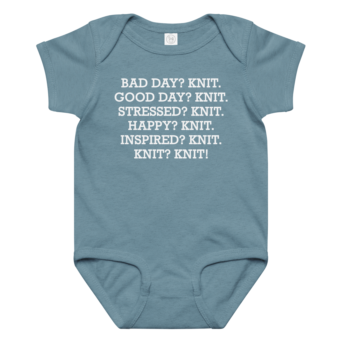 "Bad Day? Knit. Good Day? Knit. Stressed? Knit. Happy? Knit. Inspired? Knit. Knit? Knit!" printed on a vintage indigo baby jersey bodysuit laying on a flat surface amongst other clothes