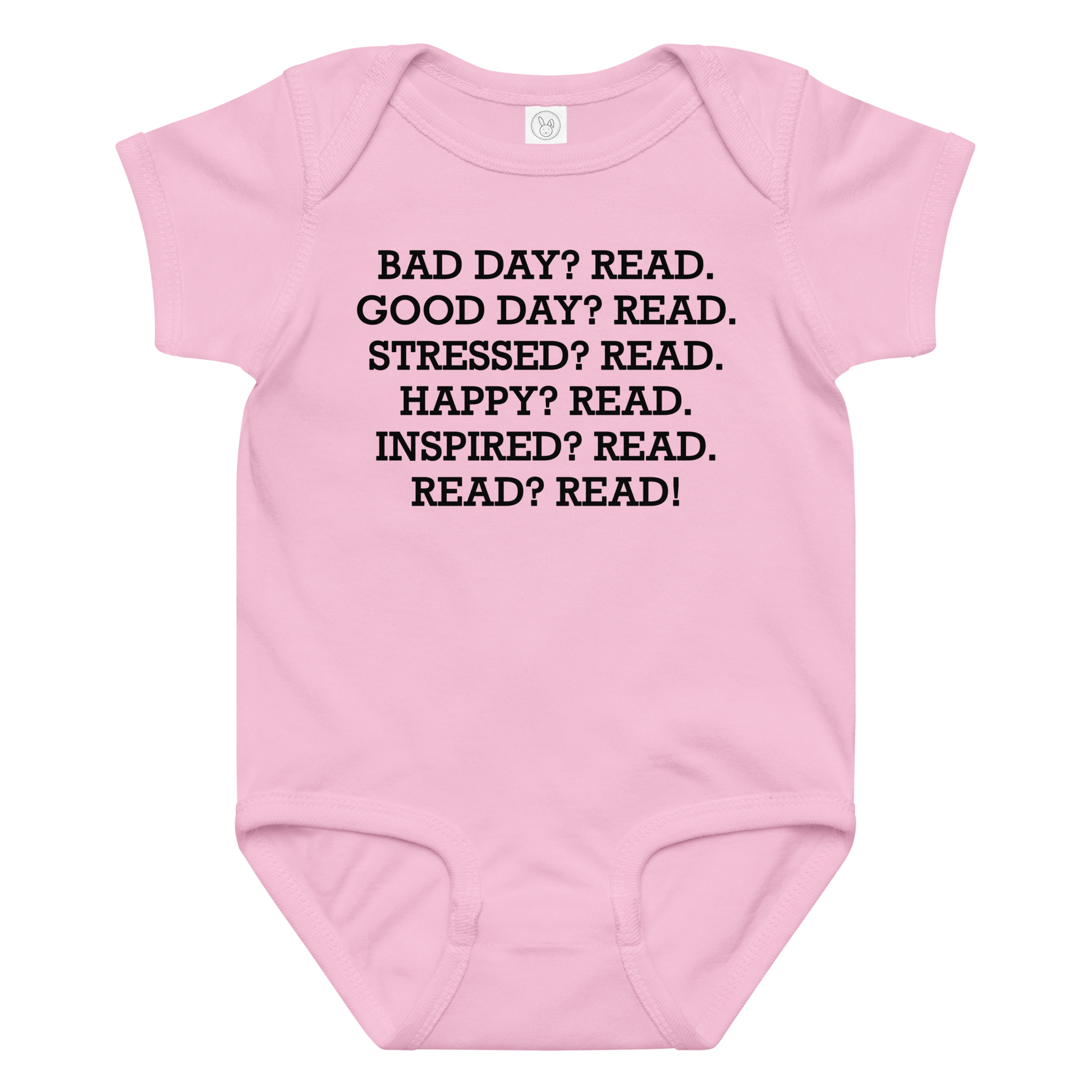 "Bad Day? Read. Good Day? Read. Stressed? Read. Happy? Read. Inspired? Read. Read? Read!" printed on a pink baby jersey bodysuit laying on a flat surface amongst other clothes