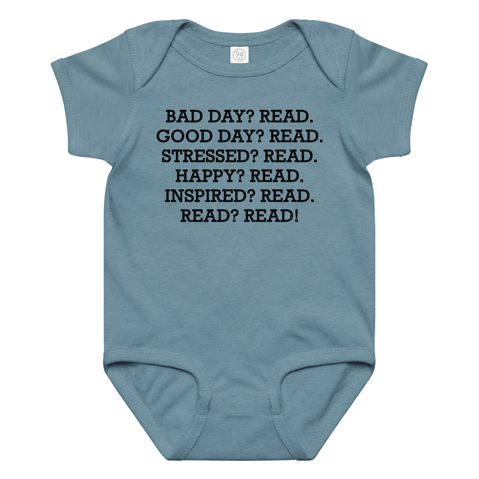 "Bad Day? Read. Good Day? Read. Stressed? Read. Happy? Read. Inspired? Read. Read? Read!" printed on a vintage indigo baby jersey bodysuit laying on a flat surface amongst other clothes
