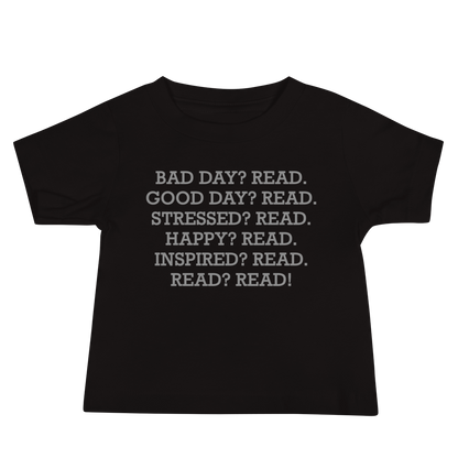 "Bad Day? Read. Good Day? Read. Stressed? Read. Happy? Read. Inspired? Read. Read? Read!" printed on a black baby jersey short sleeve tee laying on a flat surface