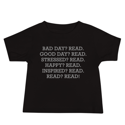 "Bad Day? Read. Good Day? Read. Stressed? Read. Happy? Read. Inspired? Read. Read? Read!" printed on a black baby jersey short sleeve tee laying on a flat surface