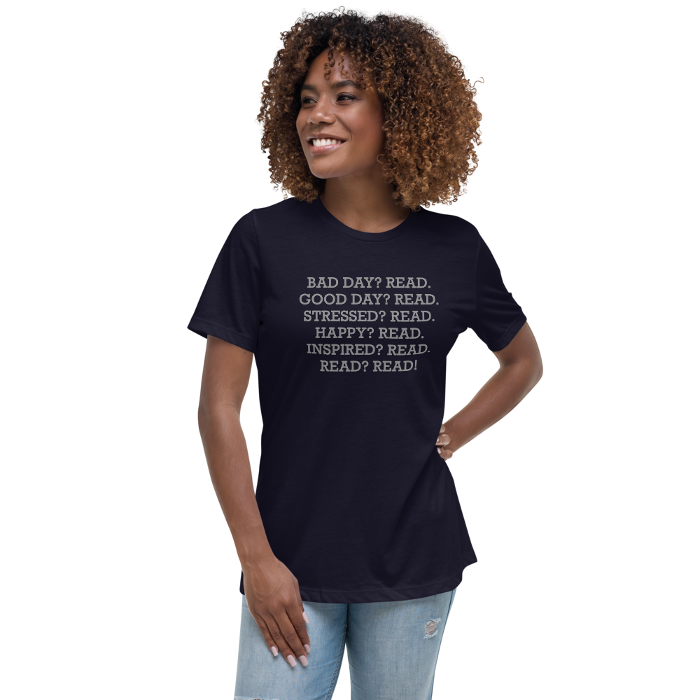 "Bad Day? Read. Good Day? Read. Stressed? Read. Happy? Read. Inspired? Read. Read? Read!" printed on a navy women's relaxed t-shirt worn by a female
