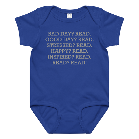 "Bad Day? Read. Good Day? Read. Stressed? Read. Happy? Read. Inspired? Read. Read? Read!" printed on a royal baby jersey bodysuit laying on a flat surface amongst other clothes
