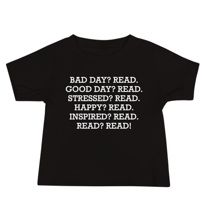 "Bad Day? Read. Good Day? Read. Stressed? Read. Happy? Read. Inspired? Read. Read? Read!" printed on a black baby jersey short sleeve tee laying on a flat surface