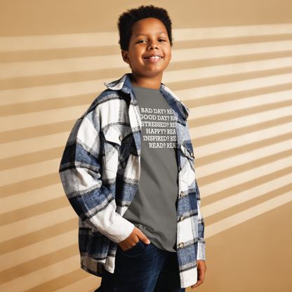 "Bad Day? Read. Good Day? Read. Stressed? Read. Happy? Read. Inspired? Read. Read? Read!" printed on a charcoal youth classic tee worn by a male also wearing a jacket