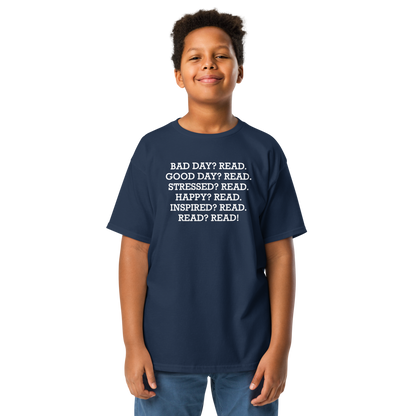 "Bad Day? Read. Good Day? Read. Stressed? Read. Happy? Read. Inspired? Read. Read? Read!" printed on a navy youth classic tee worn by a male