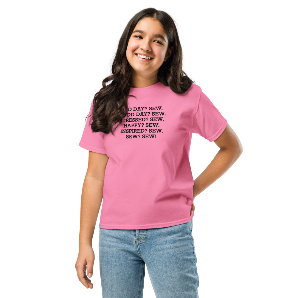 "Bad Day? Sew. Good Day? Sew. Stressed? Sew. Happy? Sew. Inspired? Sew. Sew? Sew!" printed on a azalea youth classic tee worn by a female