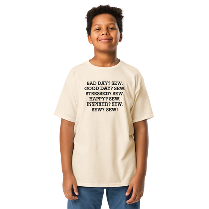 "Bad Day? Sew. Good Day? Sew. Stressed? Sew. Happy? Sew. Inspired? Sew. Sew? Sew!" printed on a natural youth classic tee worn by a male