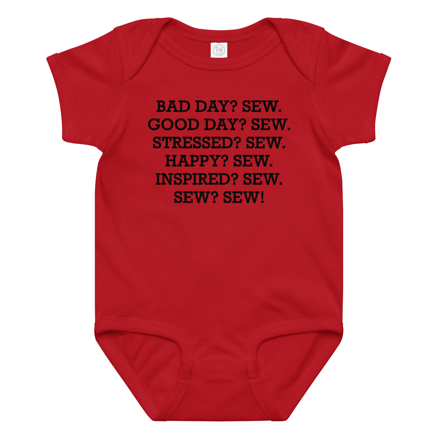 "Bad Day? Sew. Good Day? Sew. Stressed? Sew. Happy? Sew. Inspired? Sew. Sew? Sew!" printed on a red baby jersey bodysuit laying on a flat surface amongst other clothes