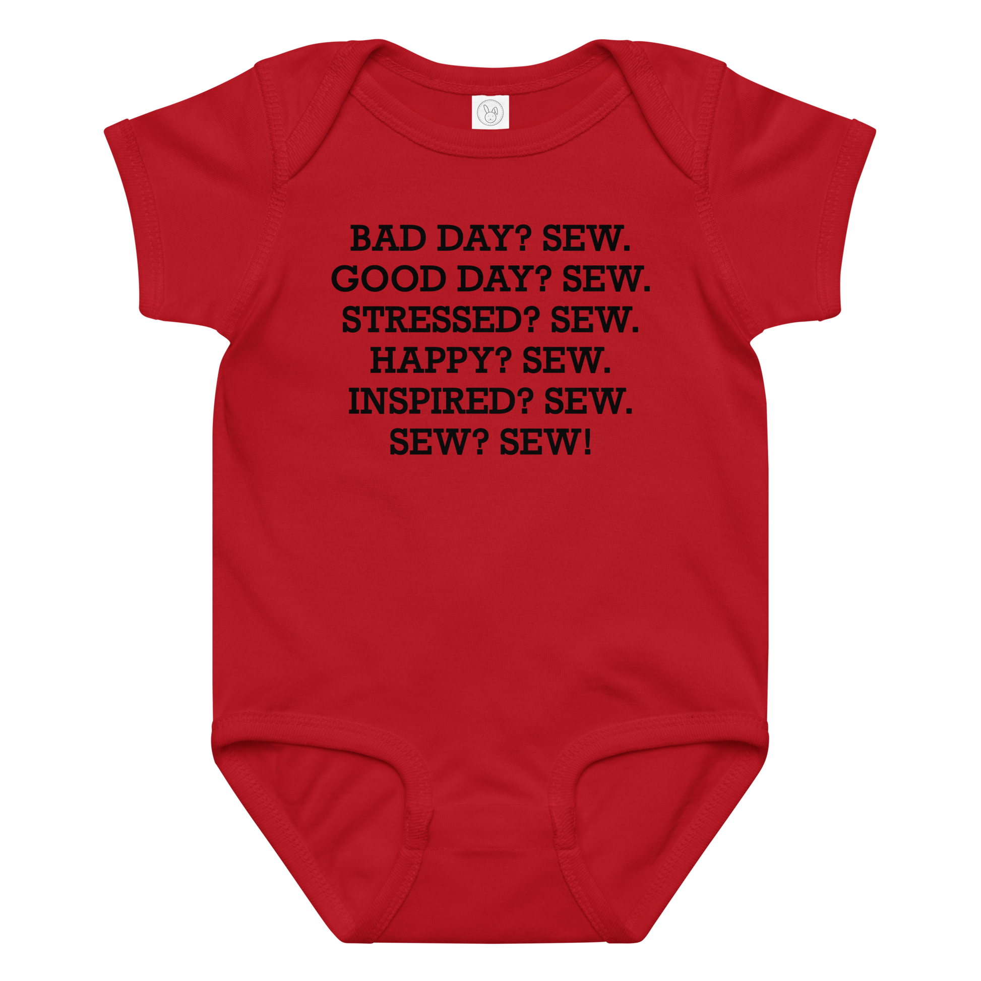 "Bad Day? Sew. Good Day? Sew. Stressed? Sew. Happy? Sew. Inspired? Sew. Sew? Sew!" printed on a red baby jersey bodysuit laying on a flat surface amongst other clothes