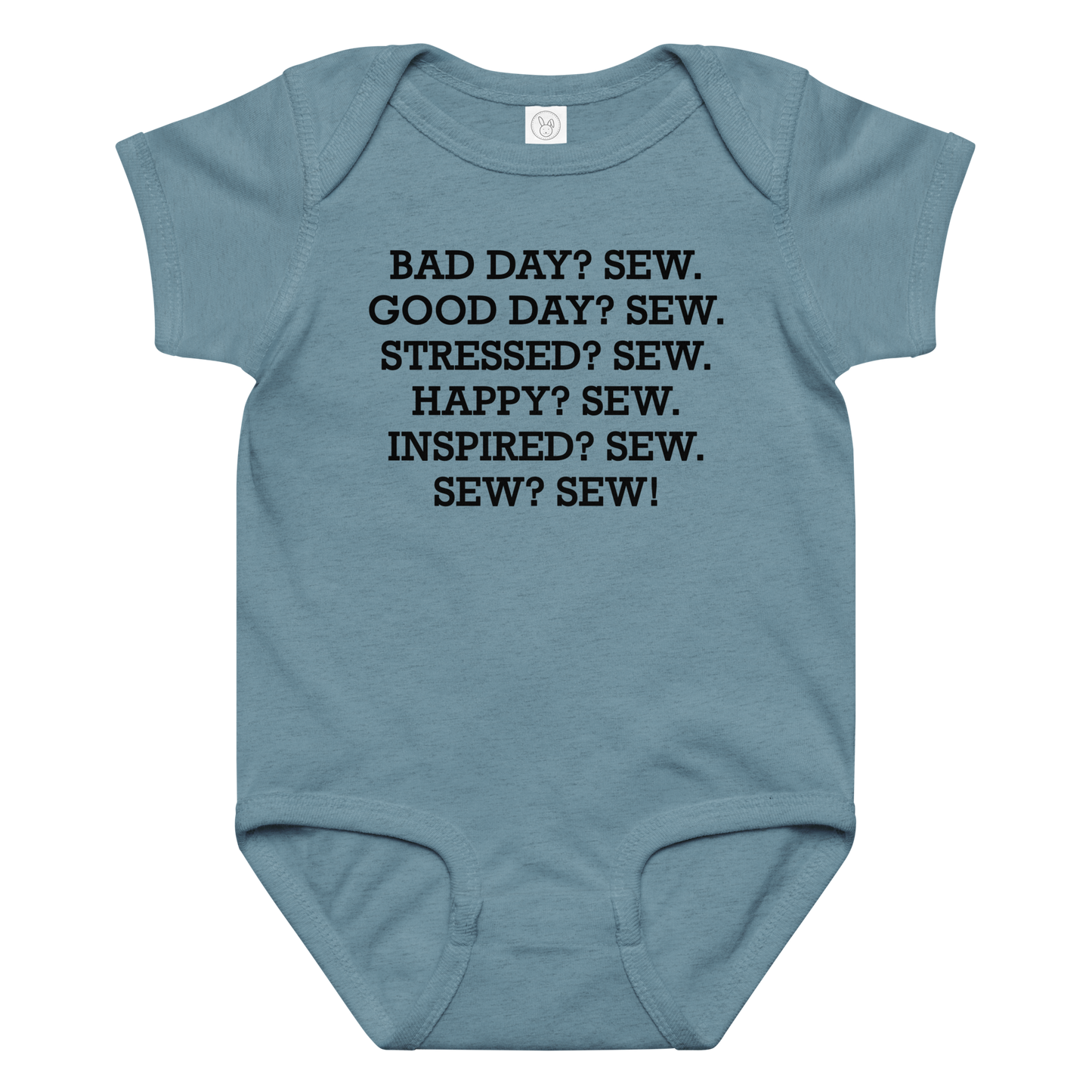 "Bad Day? Sew. Good Day? Sew. Stressed? Sew. Happy? Sew. Inspired? Sew. Sew? Sew!" printed on a vintage indigo baby jersey bodysuit laying on a flat surface amongst other clothes