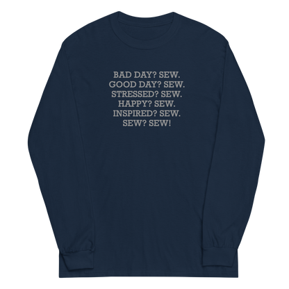 "Bad Day? Sew. Good Day? Sew. Stressed? Sew. Happy? Sew. Inspired? Sew. Sew? Sew!" printed on a navy men's long sleeve shirt laying on a flat surface