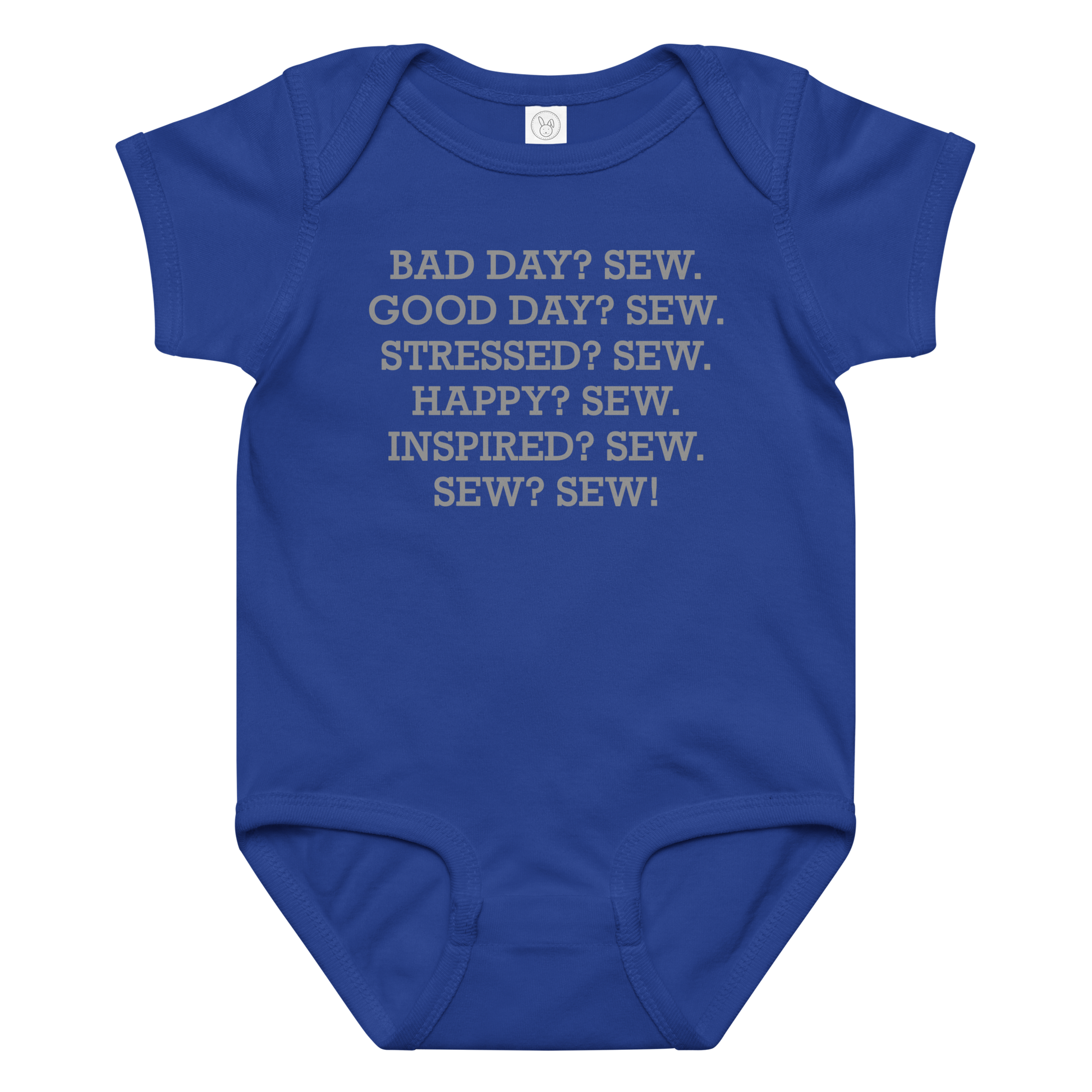 "Bad Day? Sew. Good Day? Sew. Stressed? Sew. Happy? Sew. Inspired? Sew. Sew? Sew!" printed on a royal baby jersey bodysuit laying on a flat surface amongst other clothes