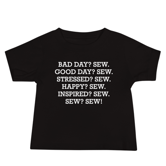 "Bad Day? Sew. Good Day? Sew. Stressed? Sew. Happy? Sew. Inspired? Sew. Sew? Sew!" printed on a black baby jersey short sleeve tee laying on a flat surface