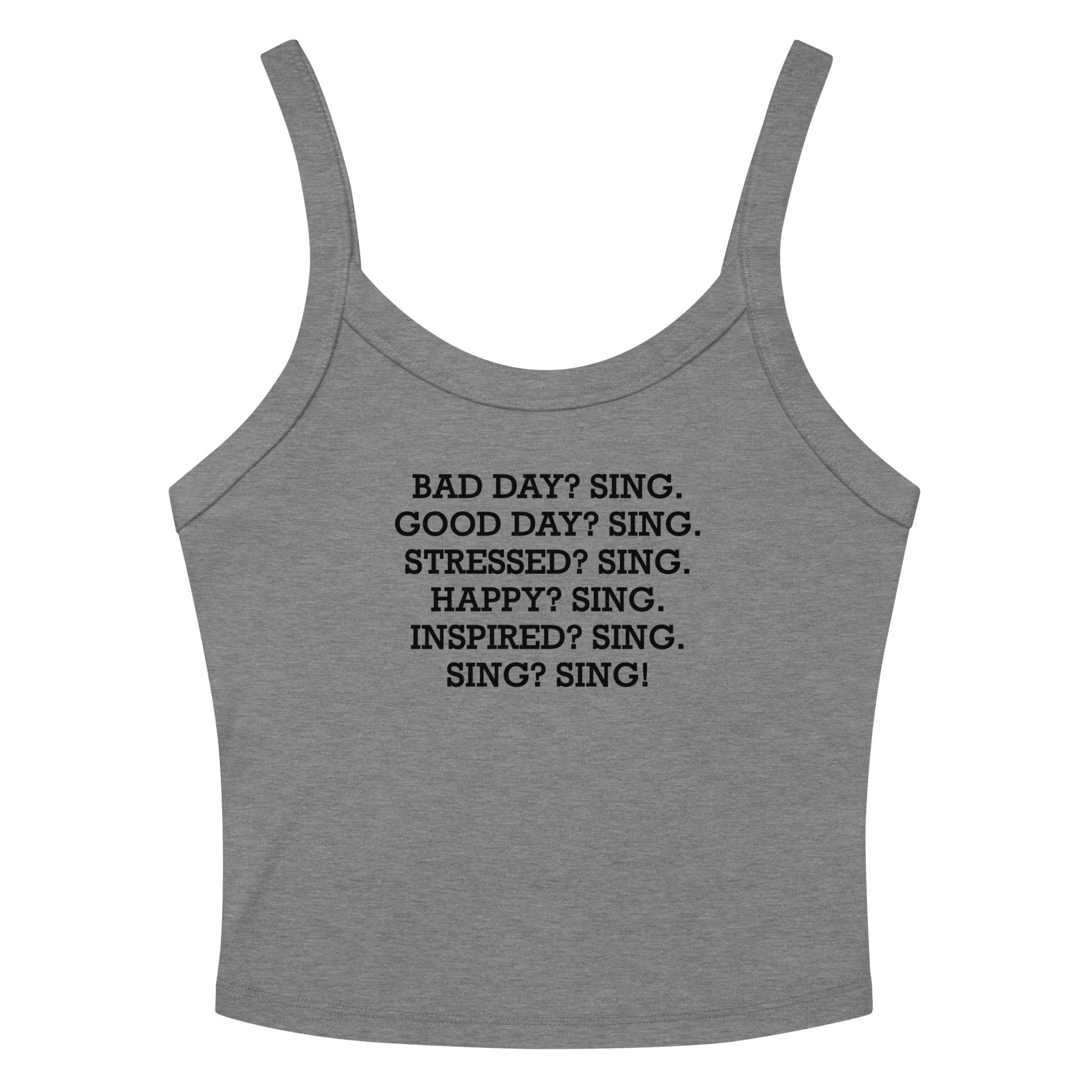 "Bad Day? Sing. Good Day? Sing. Stressed? Sing. Happy? Sing. Inspired? Sing. Sing? Sing!" printed on a athletic heather women's micro-rib tanktop laying on a flat surface amongst sunglasses and shorts
