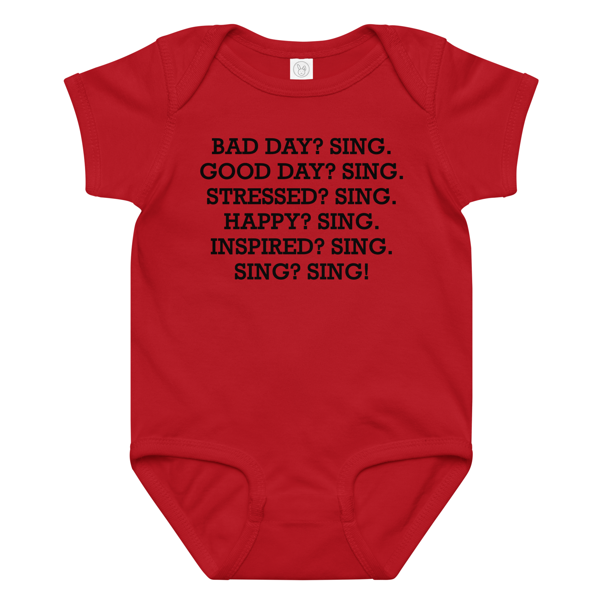 "Bad Day? Sing. Good Day? Sing. Stressed? Sing. Happy? Sing. Inspired? Sing. Sing? Sing!" printed on a red baby jersey bodysuit laying on a flat surface amongst other clothes