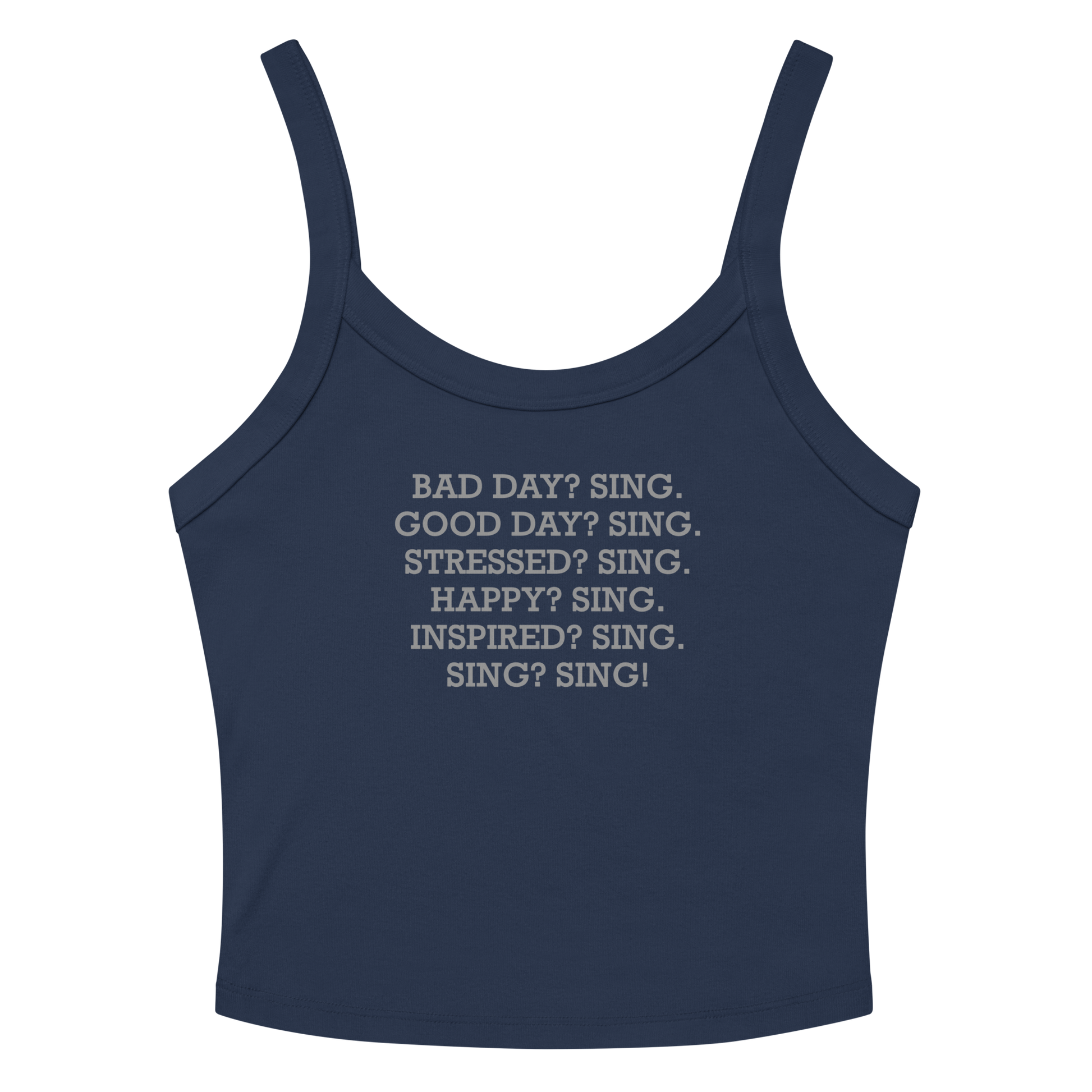 "Bad Day? Sing. Good Day? Sing. Stressed? Sing. Happy? Sing. Inspired? Sing. Sing? Sing!" printed on a solid navy blend women's micro-rib tanktop laying on a flat surface amongst sunglasses and shorts