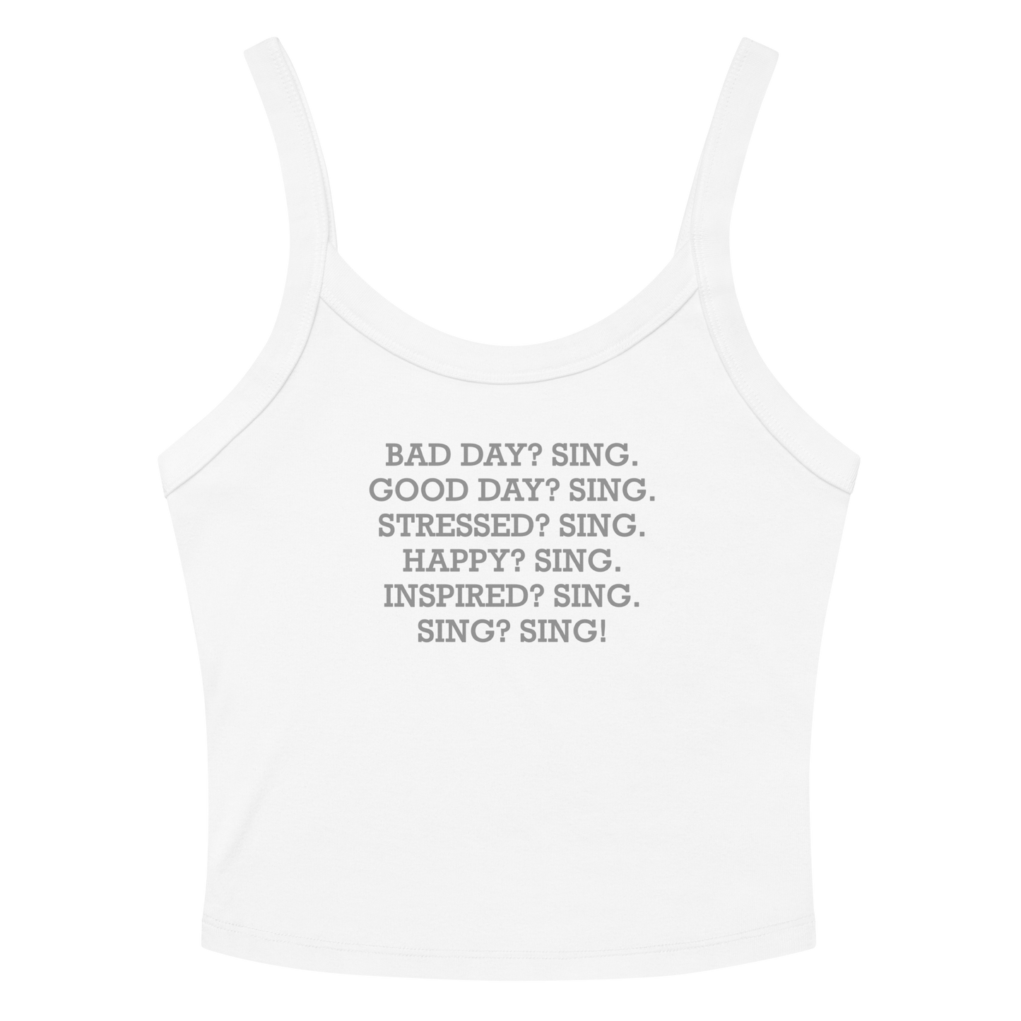 "Bad Day? Sing. Good Day? Sing. Stressed? Sing. Happy? Sing. Inspired? Sing. Sing? Sing!" printed on a solid white blend women's micro-rib tanktop laying on a flat surface amongst sunglasses and shorts
