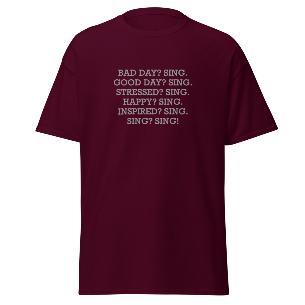 "Bad Day? Sing. Good Day? Sing. Stressed? Sing. Happy? Sing. Inspired? Sing. Sing? Sing!" printed on a maroon on an invisible body