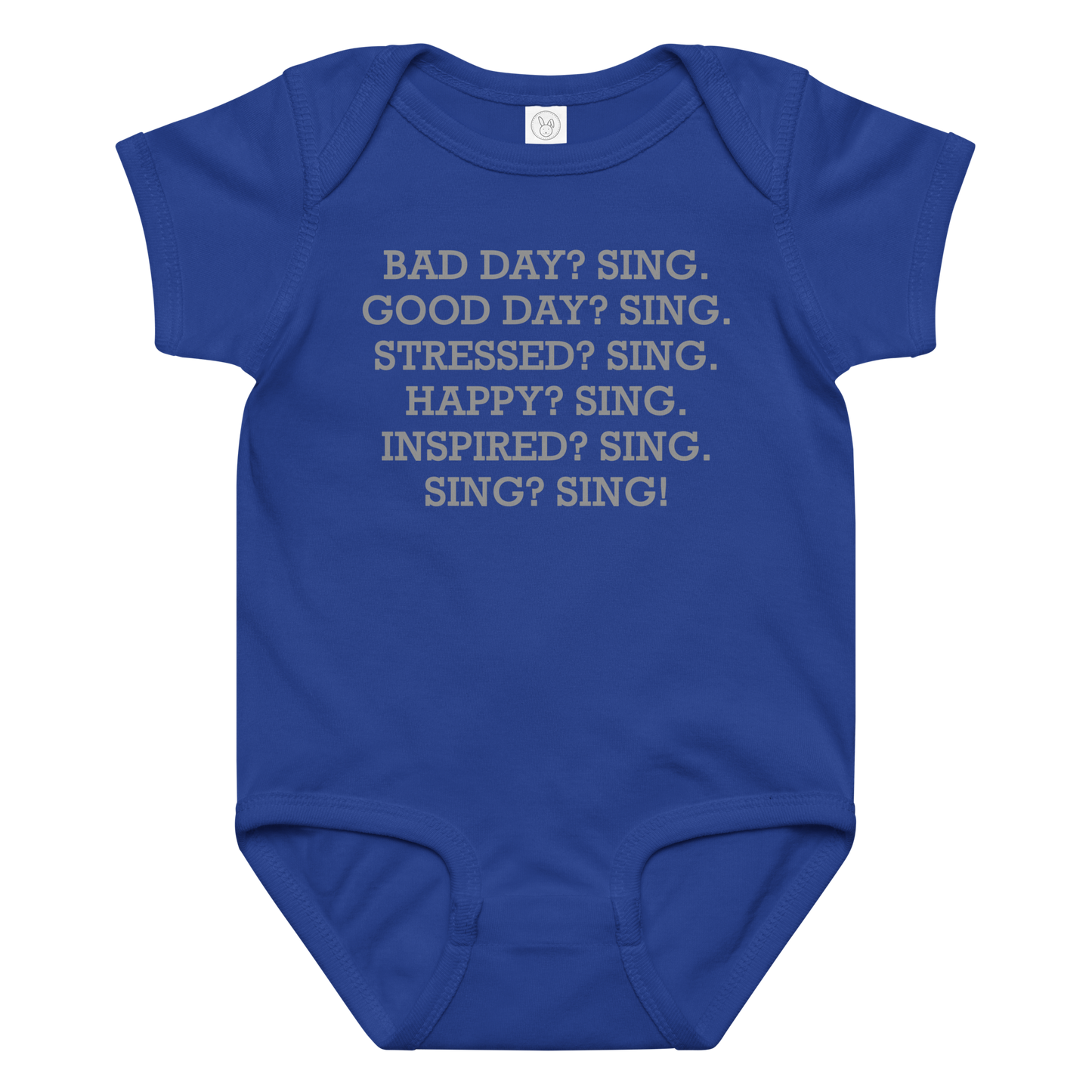 "Bad Day? Sing. Good Day? Sing. Stressed? Sing. Happy? Sing. Inspired? Sing. Sing? Sing!" printed on a royal baby jersey bodysuit laying on a flat surface amongst other clothes