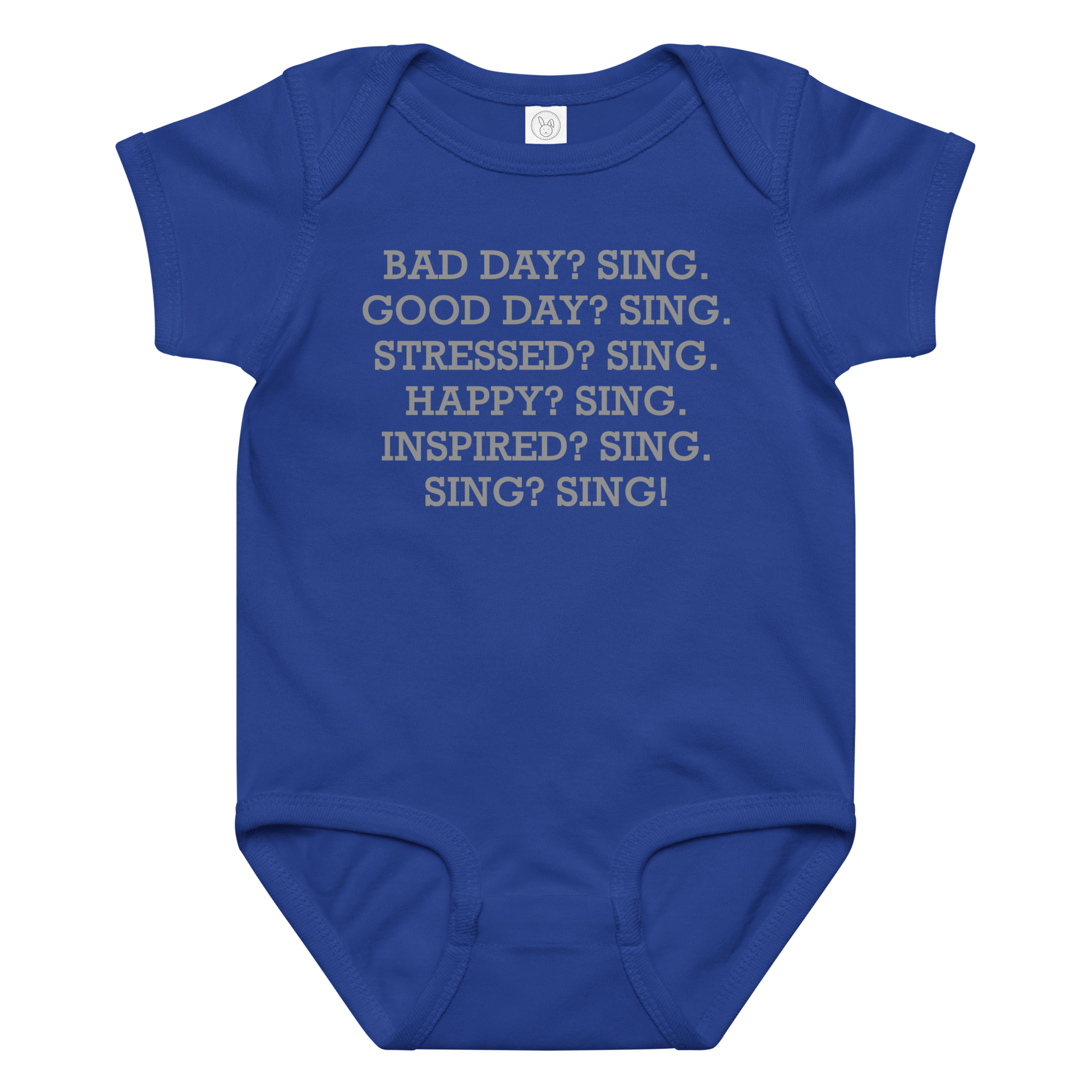 "Bad Day? Sing. Good Day? Sing. Stressed? Sing. Happy? Sing. Inspired? Sing. Sing? Sing!" printed on a royal baby jersey bodysuit laying on a flat surface amongst other clothes