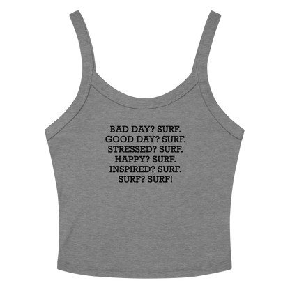 "Bad Day? Surf. Good Day? Surf. Stressed? Surf. Happy? Surf. Inspired? Surf. Surf? Surf!" printed on a athletic heather women's micro-rib tanktop laying on a flat surface amongst sunglasses and shorts
