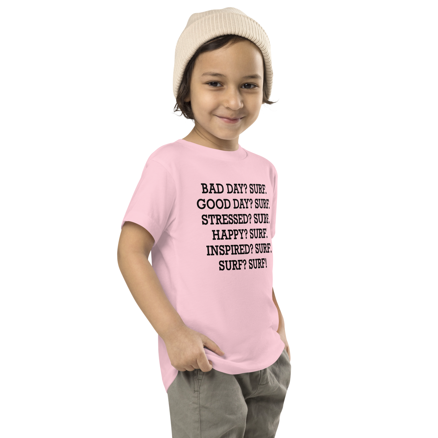 "Bad Day? Surf. Good Day? Surf. Stressed? Surf. Happy? Surf. Inspired? Surf. Surf? Surf!" printed on a pink toddler short sleeve tee worn by a male who is also wearing a knit cap