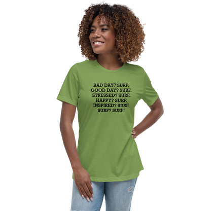 "Bad Day? Surf. Good Day? Surf. Stressed? Surf. Happy? Surf. Inspired? Surf. Surf? Surf!" printed on a leaf women's relaxed t-shirt worn by a female