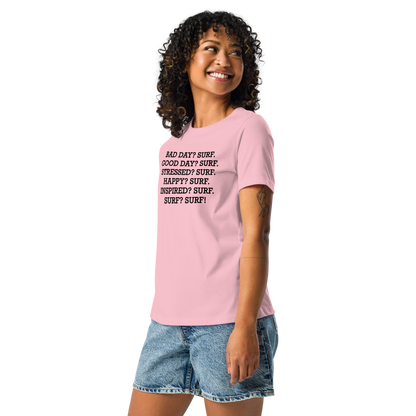 "Bad Day? Surf. Good Day? Surf. Stressed? Surf. Happy? Surf. Inspired? Surf. Surf? Surf!" printed on a pink women's relaxed t-shirt worn by a female