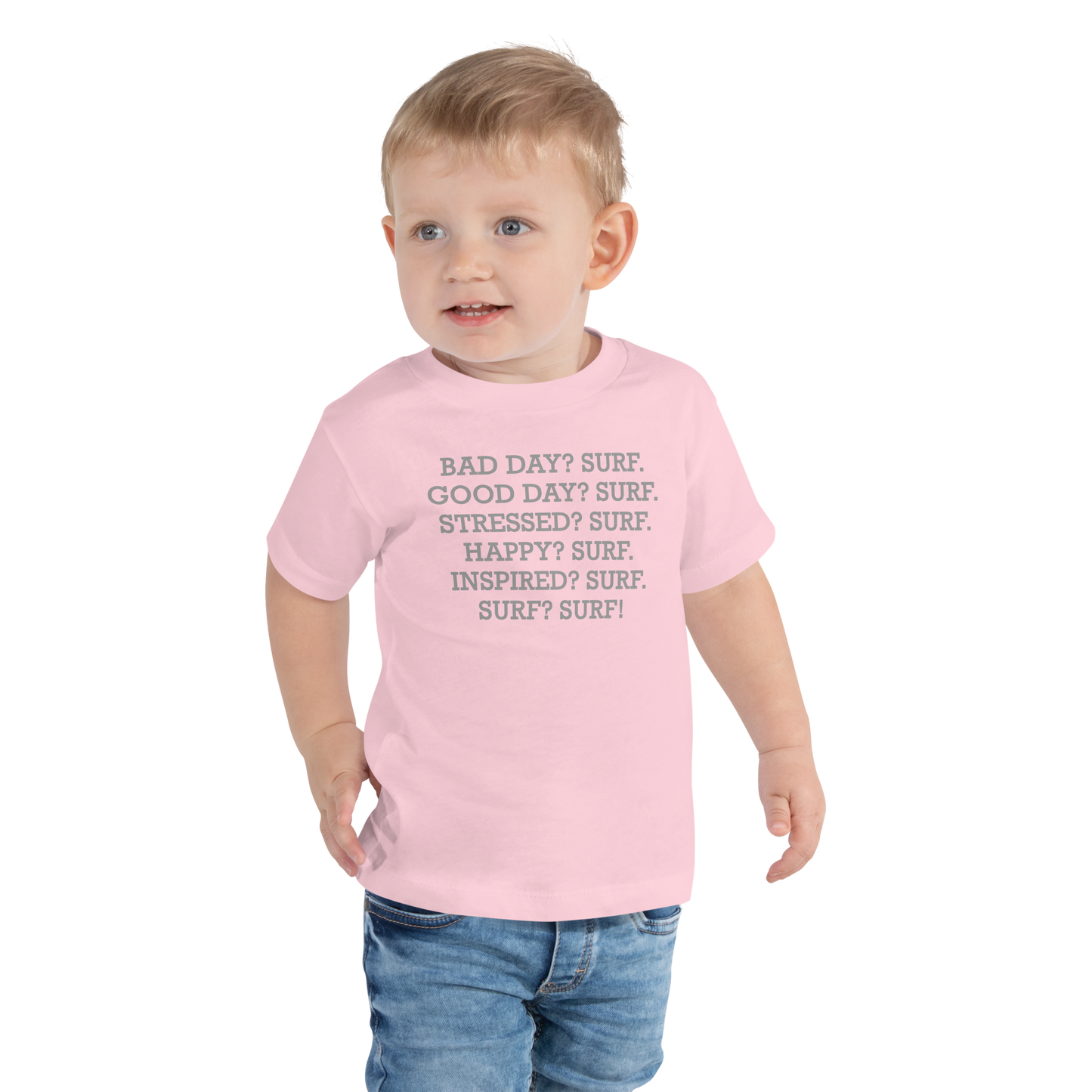 "Bad Day? Surf. Good Day? Surf. Stressed? Surf. Happy? Surf. Inspired? Surf. Surf? Surf!" printed on a pink toddler short sleeve tee worn by a male