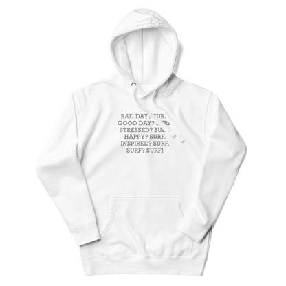 "Bad Day? Surf. Good Day? Surf. Stressed? Surf. Happy? Surf. Inspired? Surf. Surf? Surf!" printed on a white unisex hoodie laying on a flat surface with the hood up
