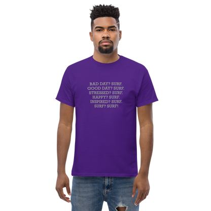 "Bad Day? Surf. Good Day? Surf. Stressed? Surf. Happy? Surf. Inspired? Surf. Surf? Surf!" printed on a purple unisex classic tee worn by a male