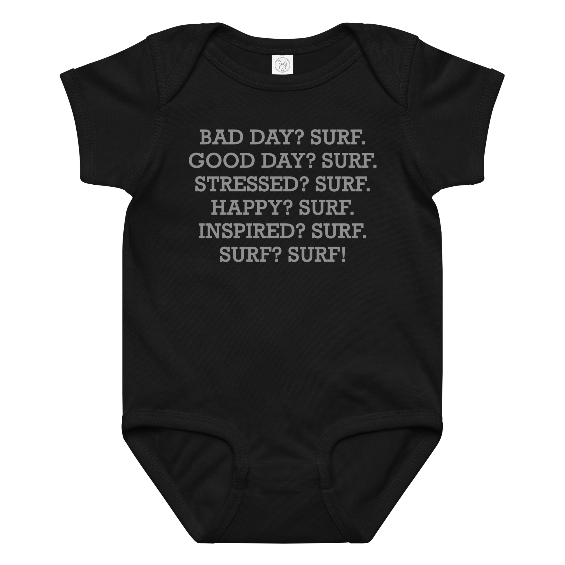 "Bad Day? Surf. Good Day? Surf. Stressed? Surf. Happy? Surf. Inspired? Surf. Surf? Surf!" printed on a black baby jersey bodysuit laying on a flat surface amongst other clothes