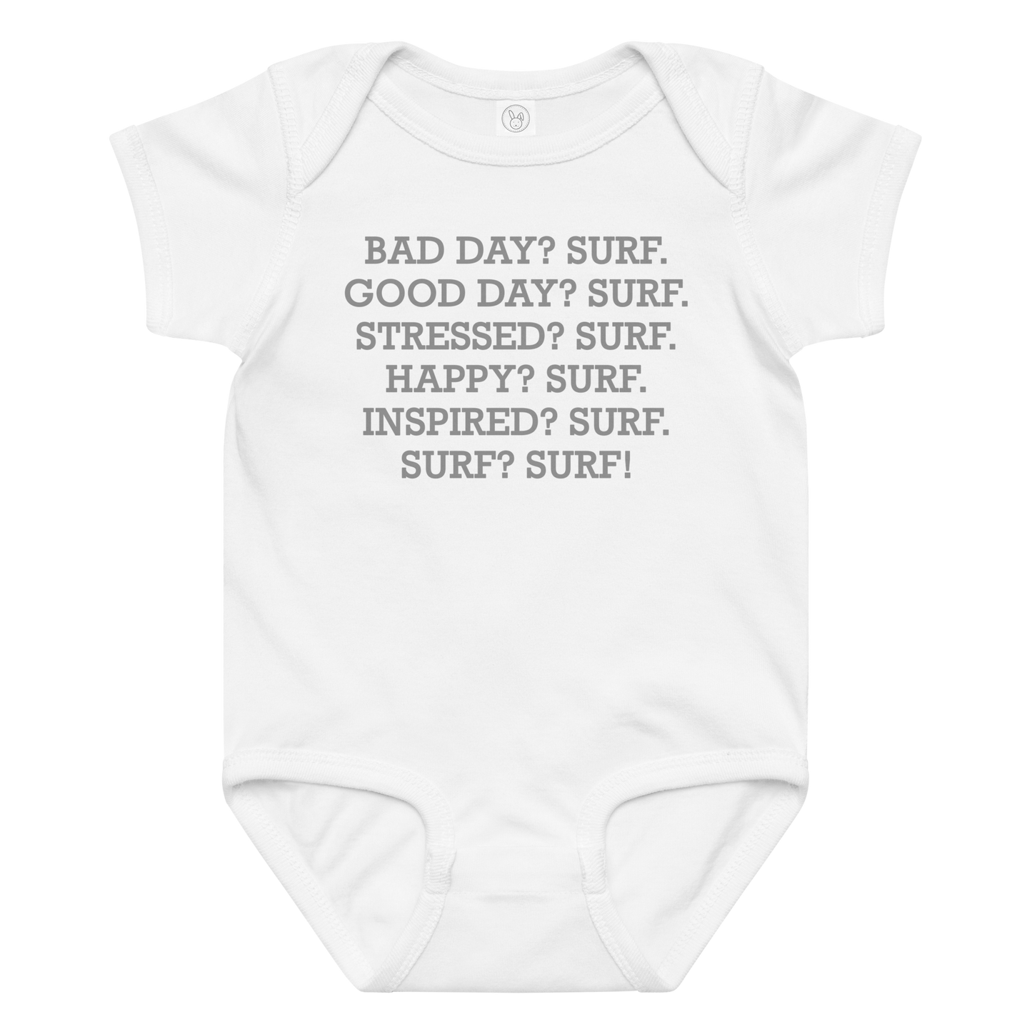 "Bad Day? Surf. Good Day? Surf. Stressed? Surf. Happy? Surf. Inspired? Surf. Surf? Surf!" printed on a white baby jersey bodysuit laying on a flat surface amongst other clothes