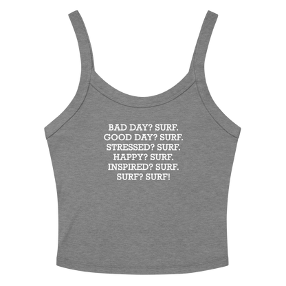 "Bad Day? Surf. Good Day? Surf. Stressed? Surf. Happy? Surf. Inspired? Surf. Surf? Surf!" printed on a athletic heather women's micro-rib tanktop laying on a flat surface amongst sunglasses and shorts