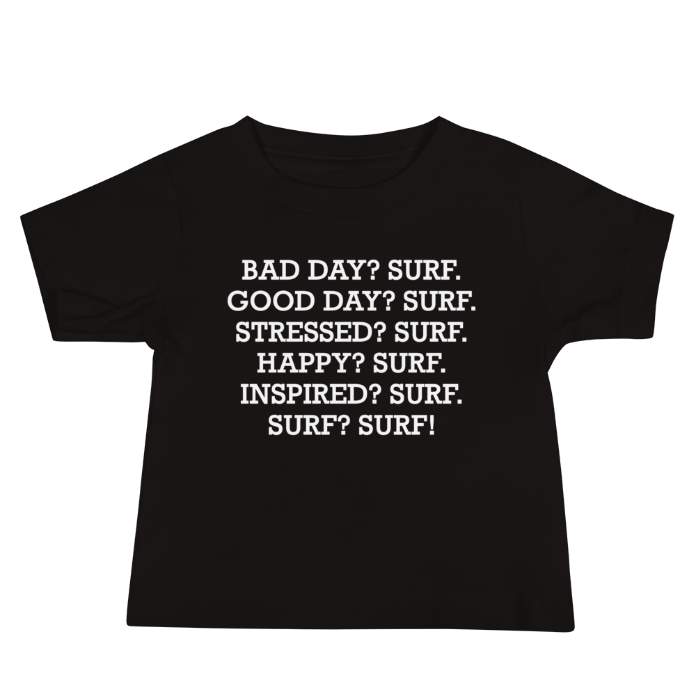 "Bad Day? Surf. Good Day? Surf. Stressed? Surf. Happy? Surf. Inspired? Surf. Surf? Surf!" printed on a black baby jersey short sleeve tee laying on a flat surface