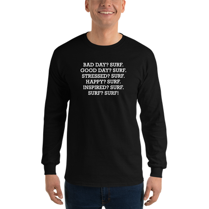"Bad Day? Surf. Good Day? Surf. Stressed? Surf. Happy? Surf. Inspired? Surf. Surf? Surf!" printed on a black men's long sleeve shirt worn by a male