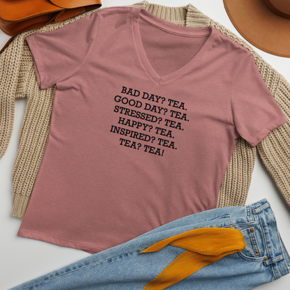 "Bad Day? Tea. Good Day? Tea. Stressed? Tea. Happy? Tea. Inspired? Tea. Tea? Tea!" printed on a heather mauve women's relaxed v-neck t-shirt laying on a flat surface amongst other clothes