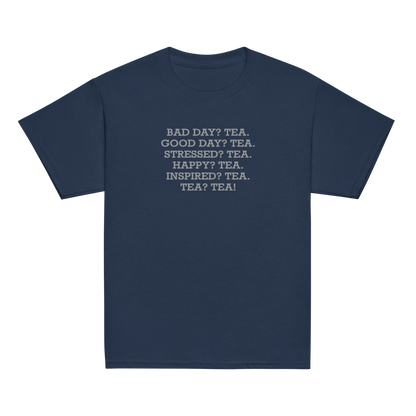 "Bad Day? Tea. Good Day? Tea. Stressed? Tea. Happy? Tea. Inspired? Tea. Tea? Tea!" printed on a navy youth classic tee laying on a flat surface