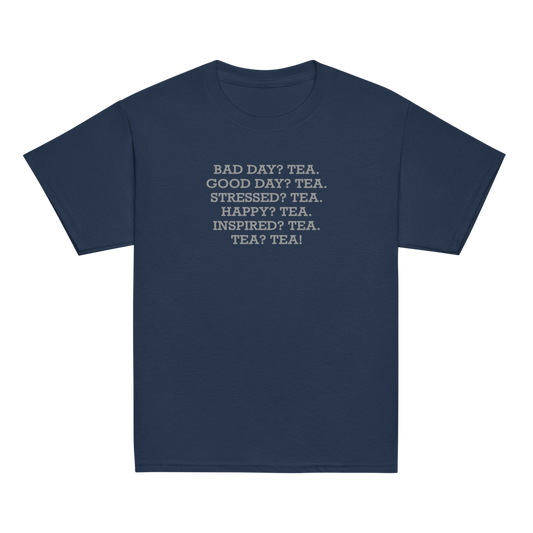 "Bad Day? Tea. Good Day? Tea. Stressed? Tea. Happy? Tea. Inspired? Tea. Tea? Tea!" printed on a navy youth classic tee laying on a flat surface