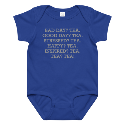 "Bad Day? Tea. Good Day? Tea. Stressed? Tea. Happy? Tea. Inspired? Tea. Tea? Tea!" printed on a royal baby jersey bodysuit laying on a flat surface amongst other clothes