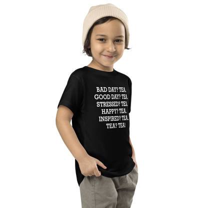 "Bad Day? Tea. Good Day? Tea. Stressed? Tea. Happy? Tea. Inspired? Tea. Tea? Tea!" printed on a black toddler short sleeve tee worn by a male who is also wearing a knit cap