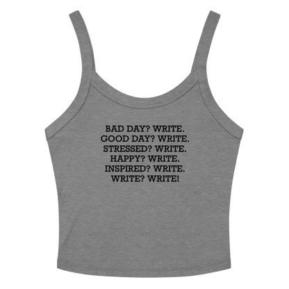 "Bad Day? Write. Good Day? Write. Stressed? Write. Happy? Write. Inspired? Write. Write? Write!" printed on a athletic heather women's micro-rib tanktop laying on a flat surface amongst sunglasses and shorts