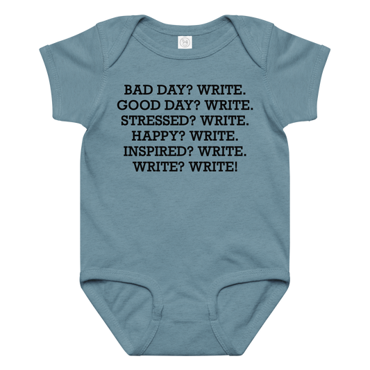 "Bad Day? Write. Good Day? Write. Stressed? Write. Happy? Write. Inspired? Write. Write? Write!" printed on a vintage indigo baby jersey bodysuit laying on a flat surface amongst other clothes