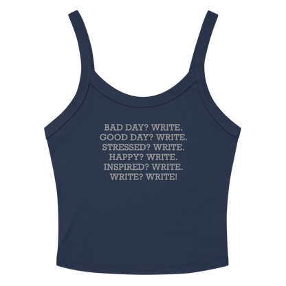 "Bad Day? Write. Good Day? Write. Stressed? Write. Happy? Write. Inspired? Write. Write? Write!" printed on a solid navy blend women's micro-rib tanktop laying on a flat surface amongst sunglasses and shorts