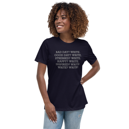 "Bad Day? Write. Good Day? Write. Stressed? Write. Happy? Write. Inspired? Write. Write? Write!" printed on a navy women's relaxed t-shirt worn by a female